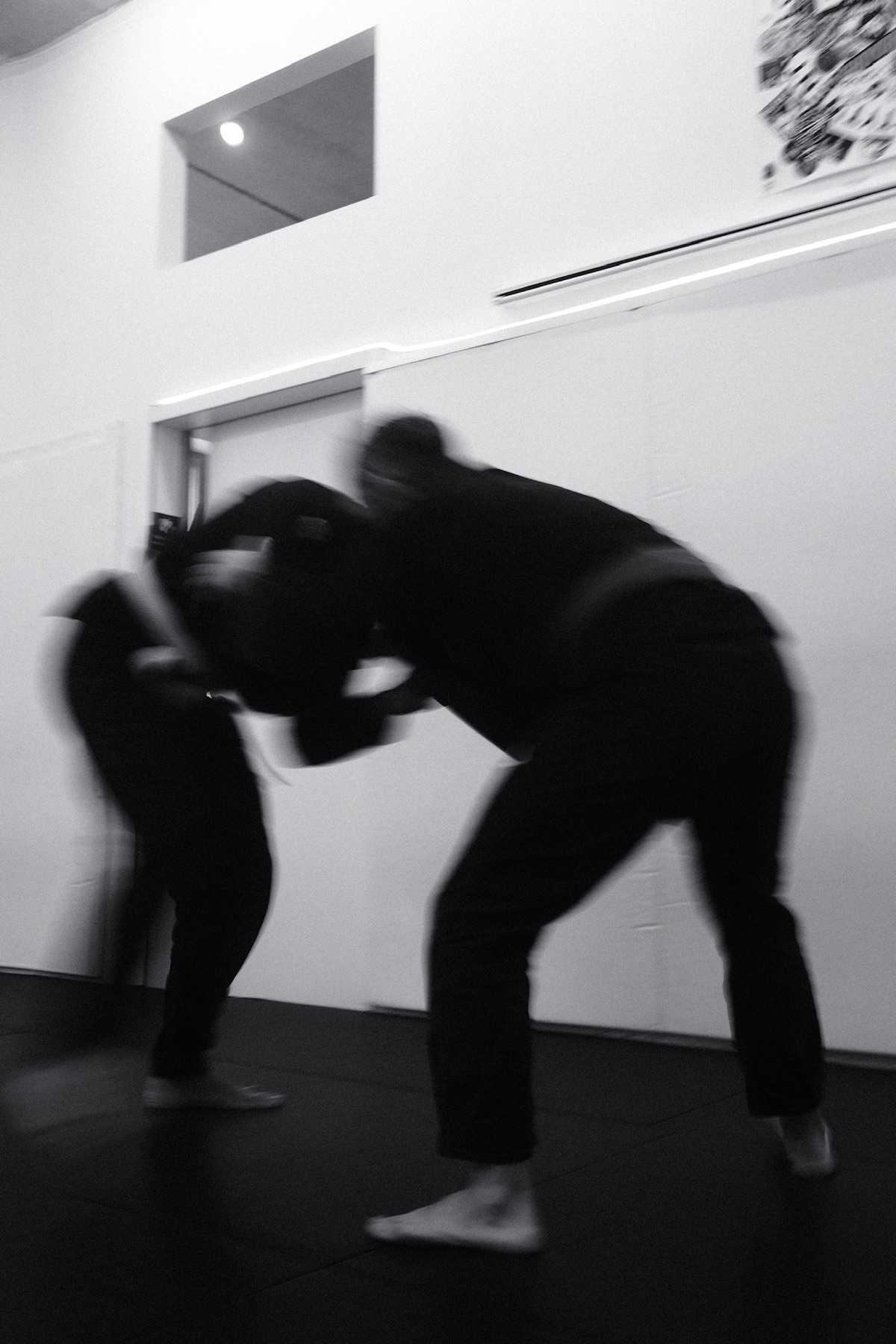 Two practitioners hand-fighting during a standing jiu-jitsu round