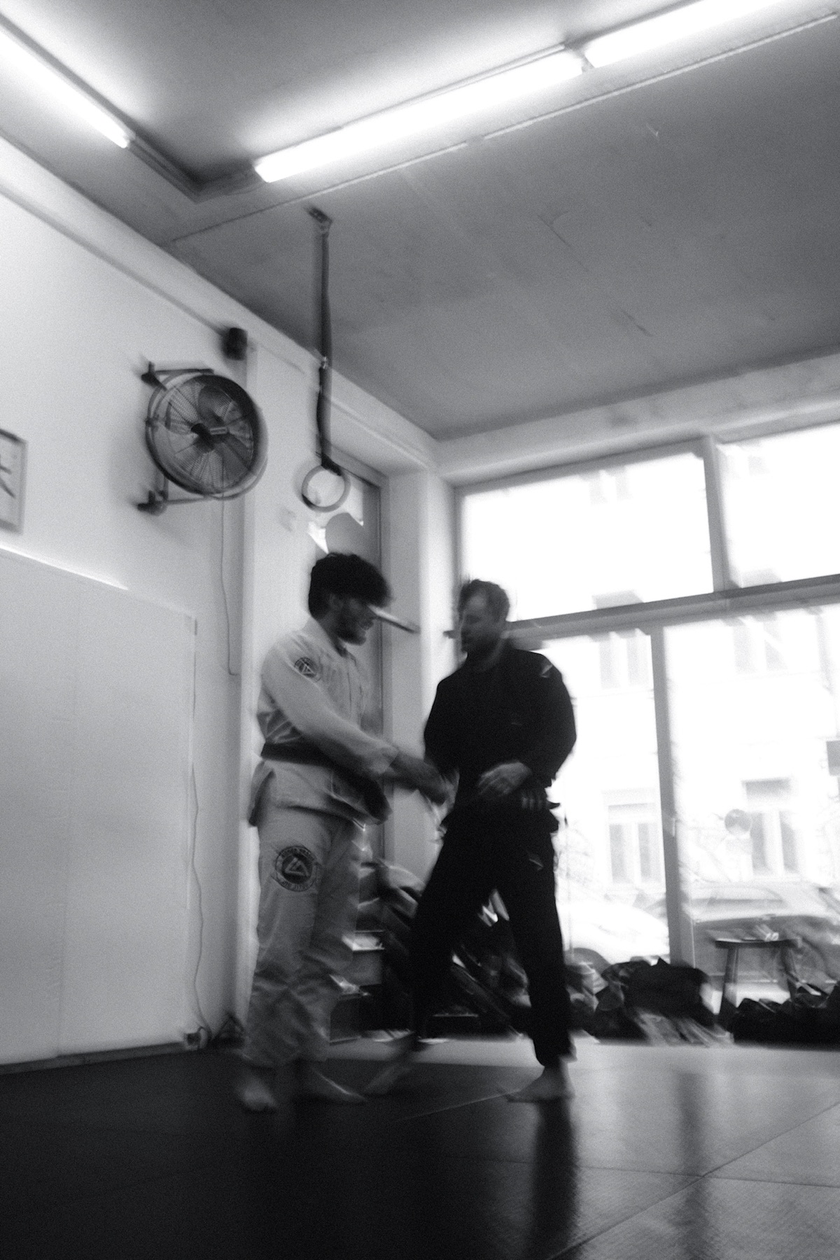 Two partners pausing between jiu-jitsu rounds